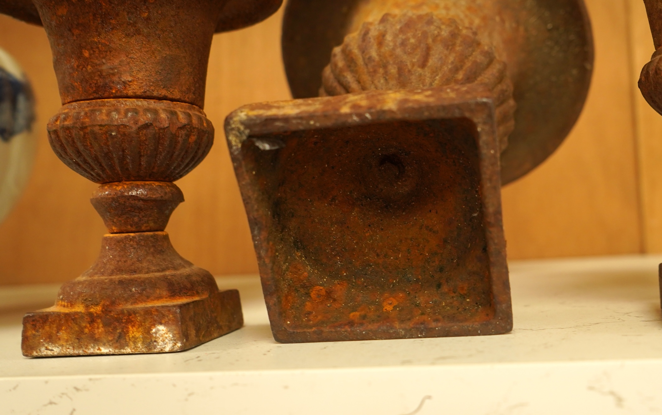 A garniture of three cast iron campana vases, largest 18cm high